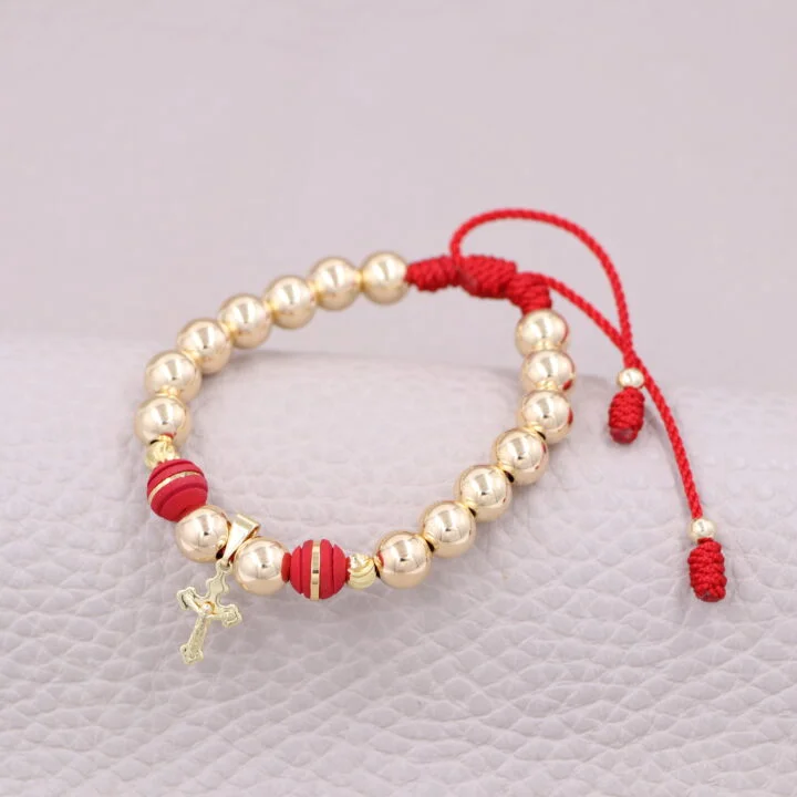 Brazalete rojo con cristo balín oro laminado 18k